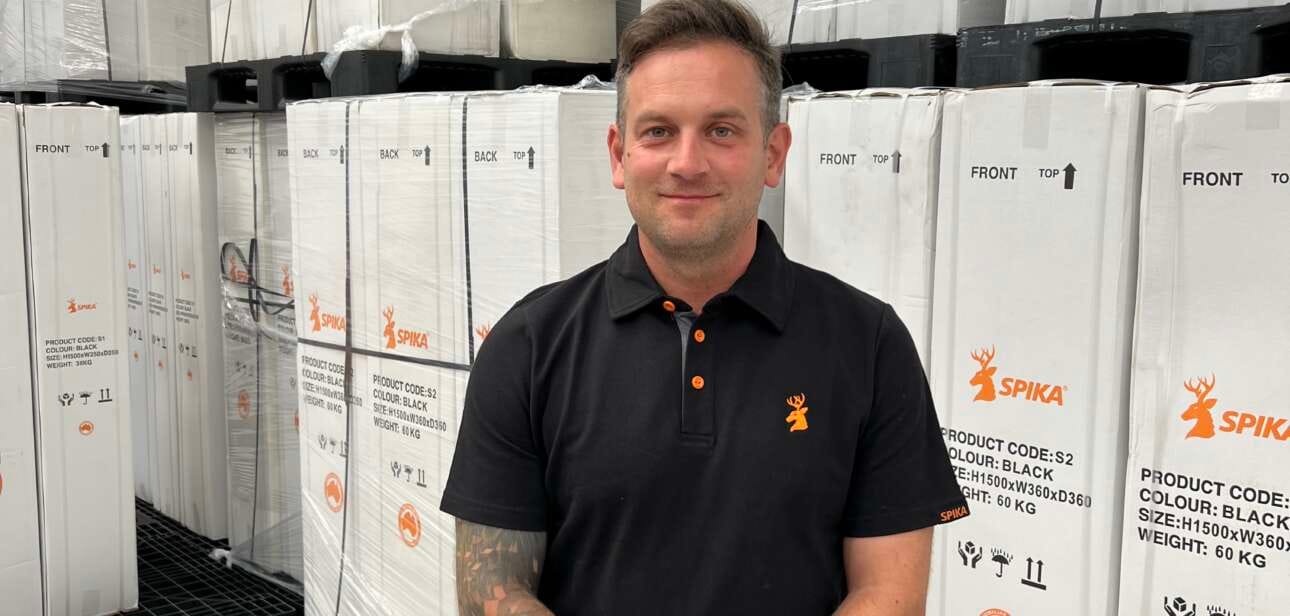 Tom Walker, manager of Eastern Sporting Trade, standing in the warehouse among newly arrived Spika gun safes, representing the brand’s UK launch.