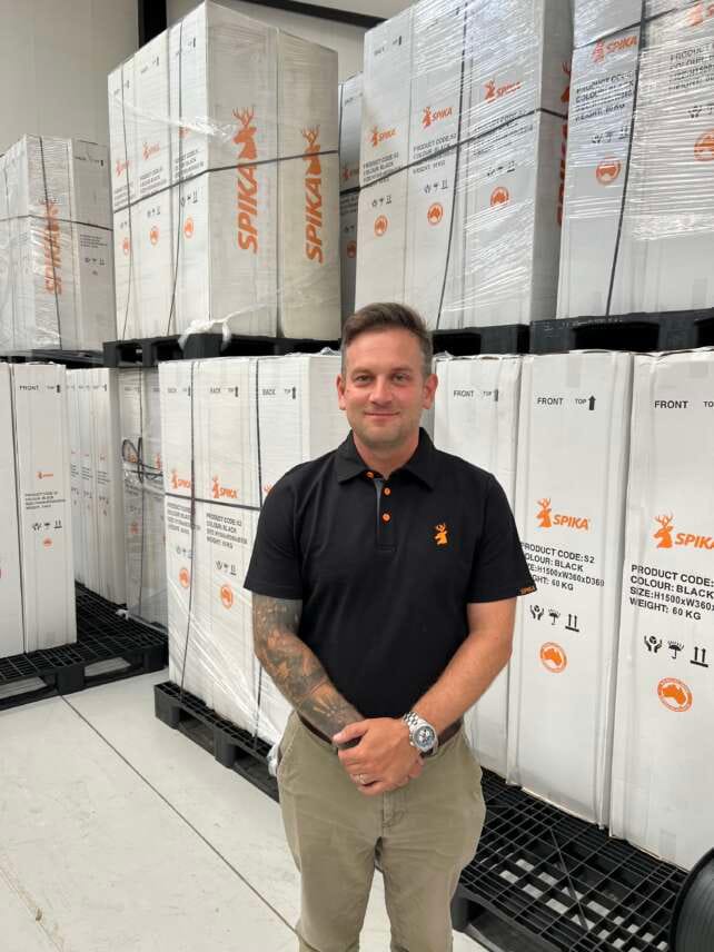 Tom Walker, manager of Eastern Sporting Trade, standing in the warehouse among newly arrived Spika gun safes, representing the brand’s UK launch.