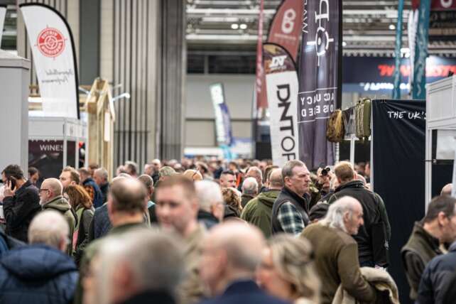 Crowds walk through a busy show hall at the Great British Shooting Show at the NEC Birmingham, with exhibitors and shooting brands on display