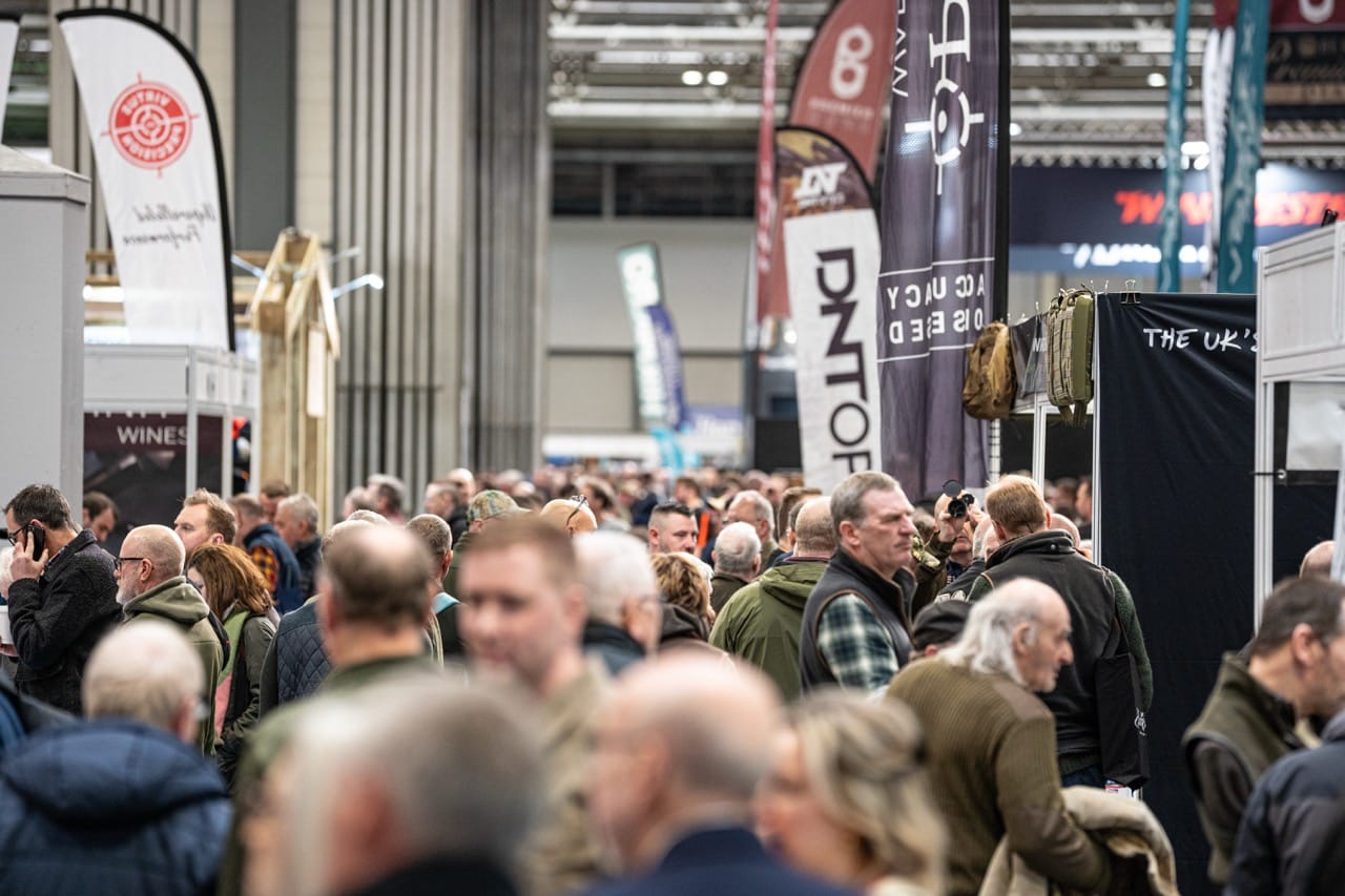 Crowds walk through a busy show hall at the Great British Shooting Show at the NEC Birmingham, with exhibitors and shooting brands on display
