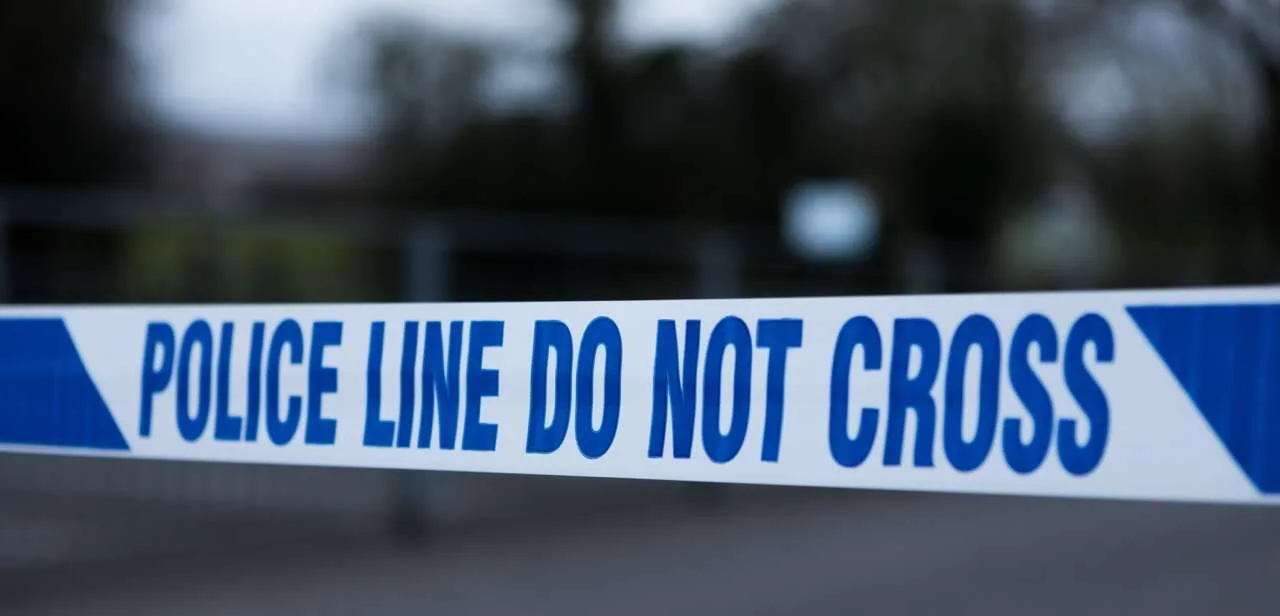 Police line tape marking a restricted area at a crime scene