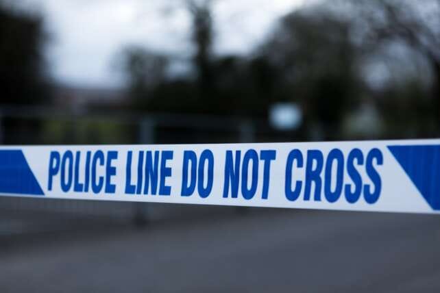 Police line tape marking a restricted area at a crime scene