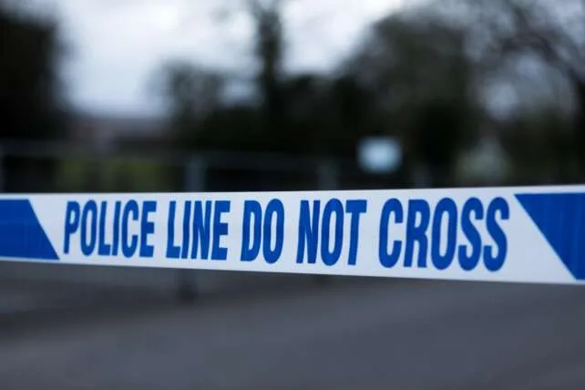 Police line tape marking a restricted area at a crime scene